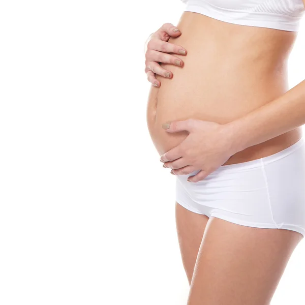 Young attractive pregnant woman with the beautiful belly over wh — Stock Photo, Image