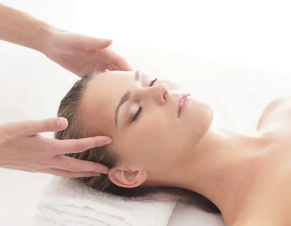 Young attractive woman getting massaging treatment over white ba — Stock Photo, Image