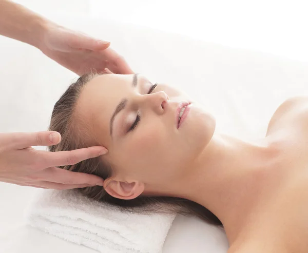 Young attractive woman getting massaging treatment over white ba — Stock Photo, Image