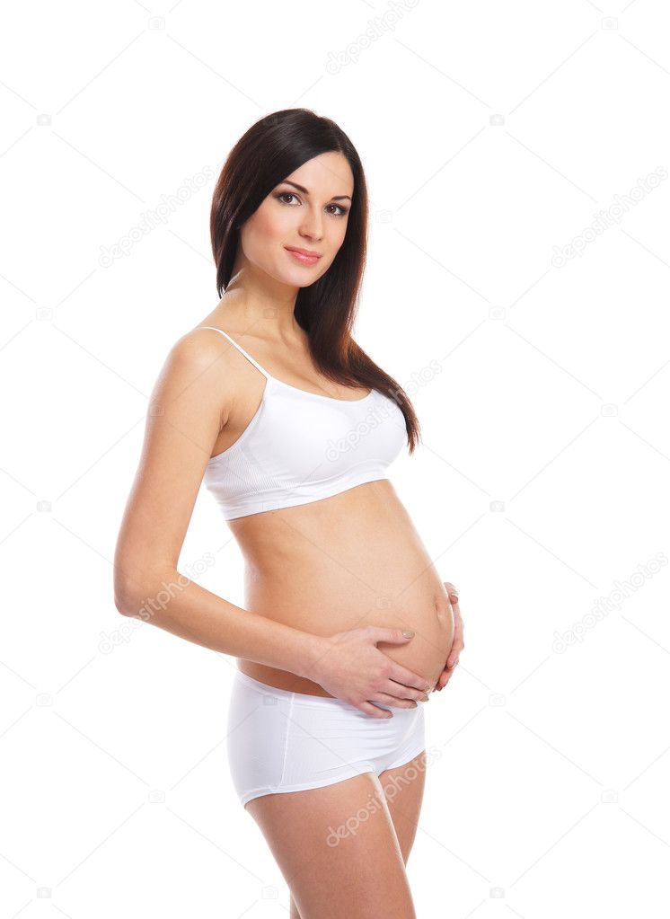 Young attractive pregnant woman with the beautiful belly over white background