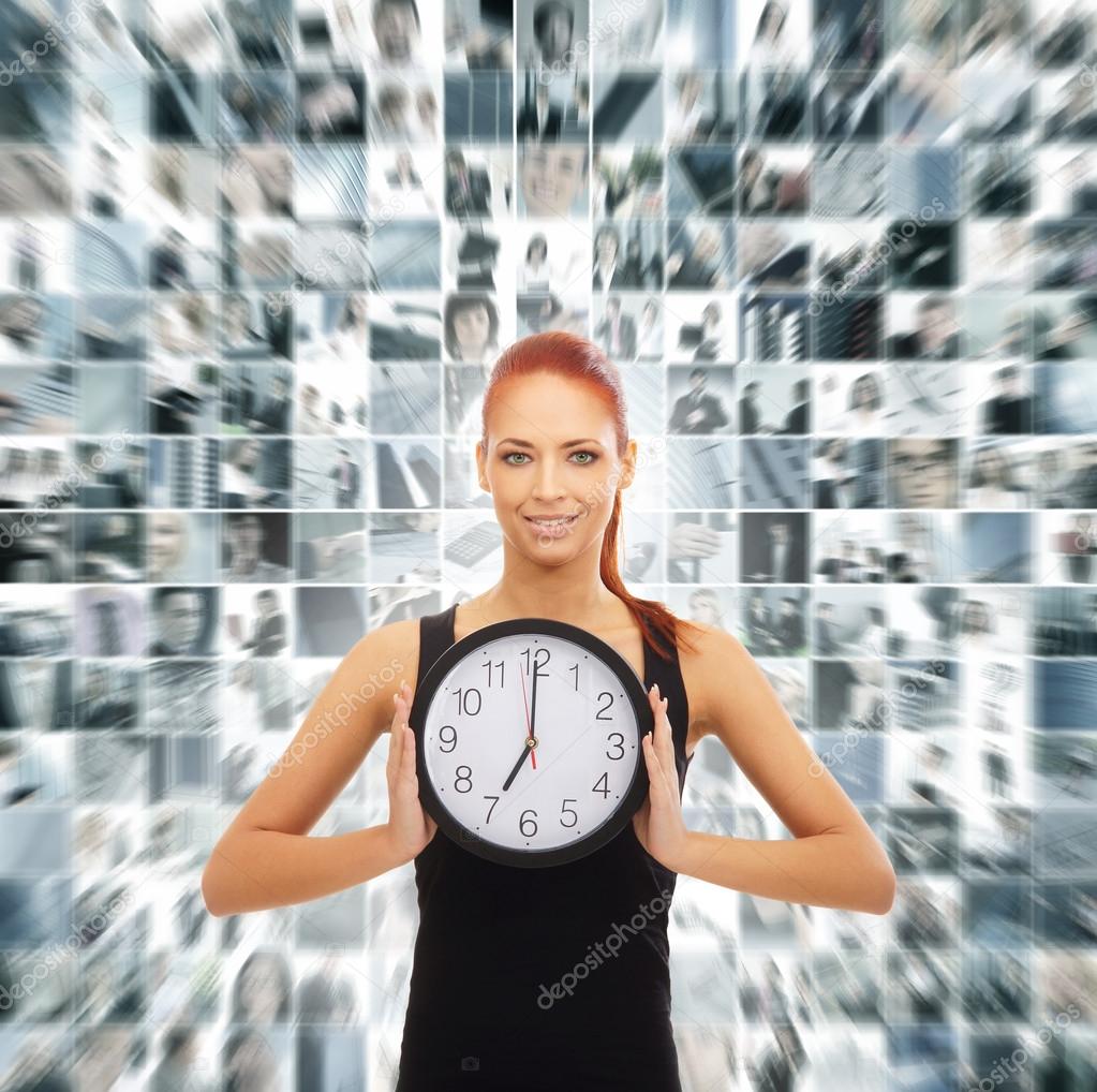 Young attractive woman showing the clock isolated on white