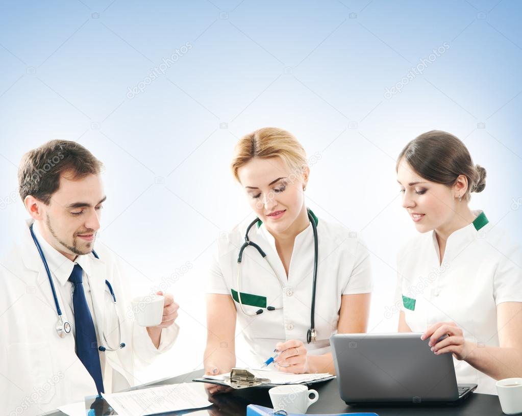 Group of medical workers discussing in office