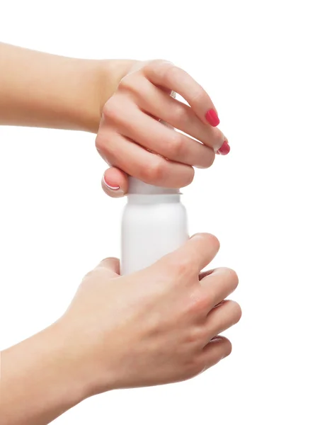 Beautiful female hands opening the bottle with a talcum powder — Stock Photo, Image