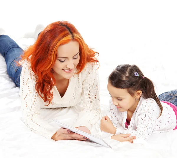 A happy mother and a young daughter on a light background — Stock Photo, Image