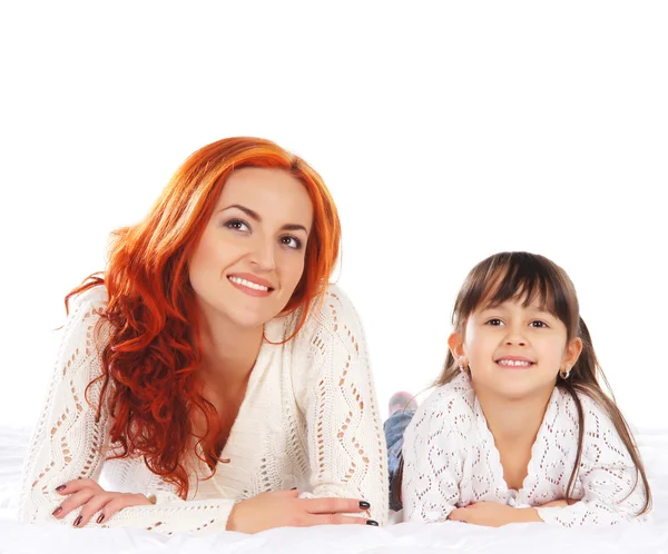 A happy mother and a young daughter on a light background — Stock Photo, Image