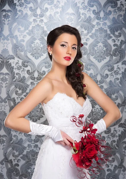 Young and beautiful bride standing with the flower bouquet — Stock Photo, Image