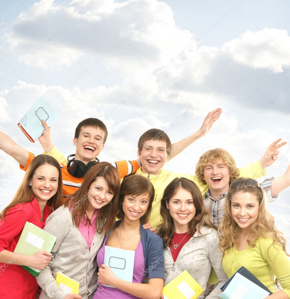 Group of smiling teenagers staying together