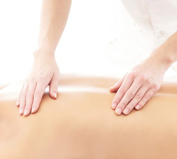 Young attractive woman getting massaging treatment over white ba — Stock Photo, Image