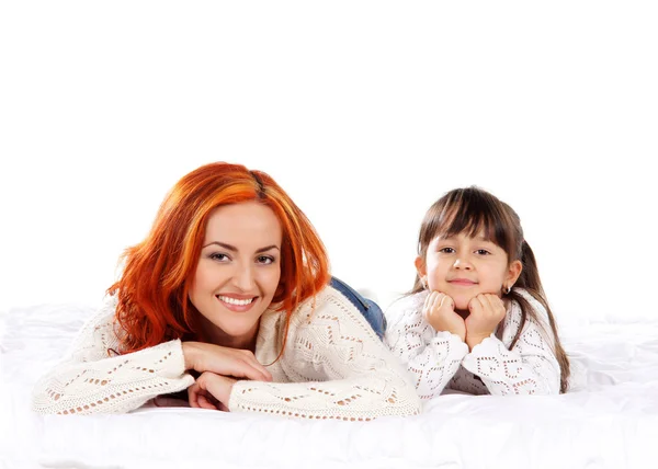 A happy mother and a young daughter on a light background — Stock Photo, Image