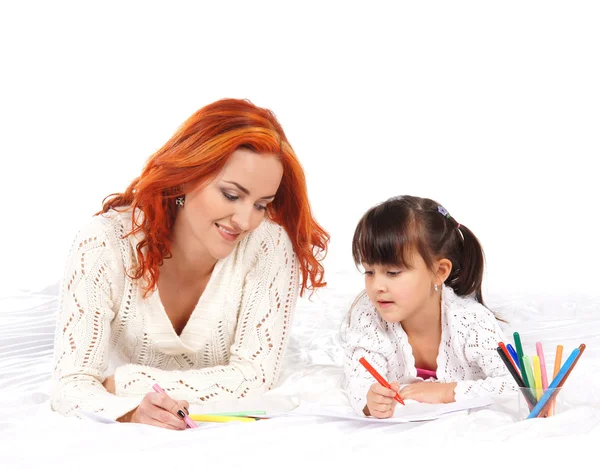 A happy mother and a young daughter on a light background — Stock Photo, Image