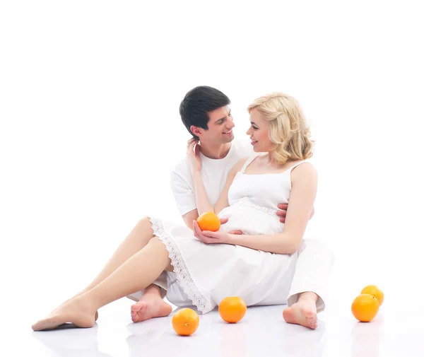 A happy couple: pregnant mother and a father on white — Stock Photo, Image