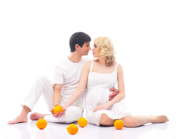 Ett lyckligt par: gravid mamma och en pappa på vit — Stockfoto