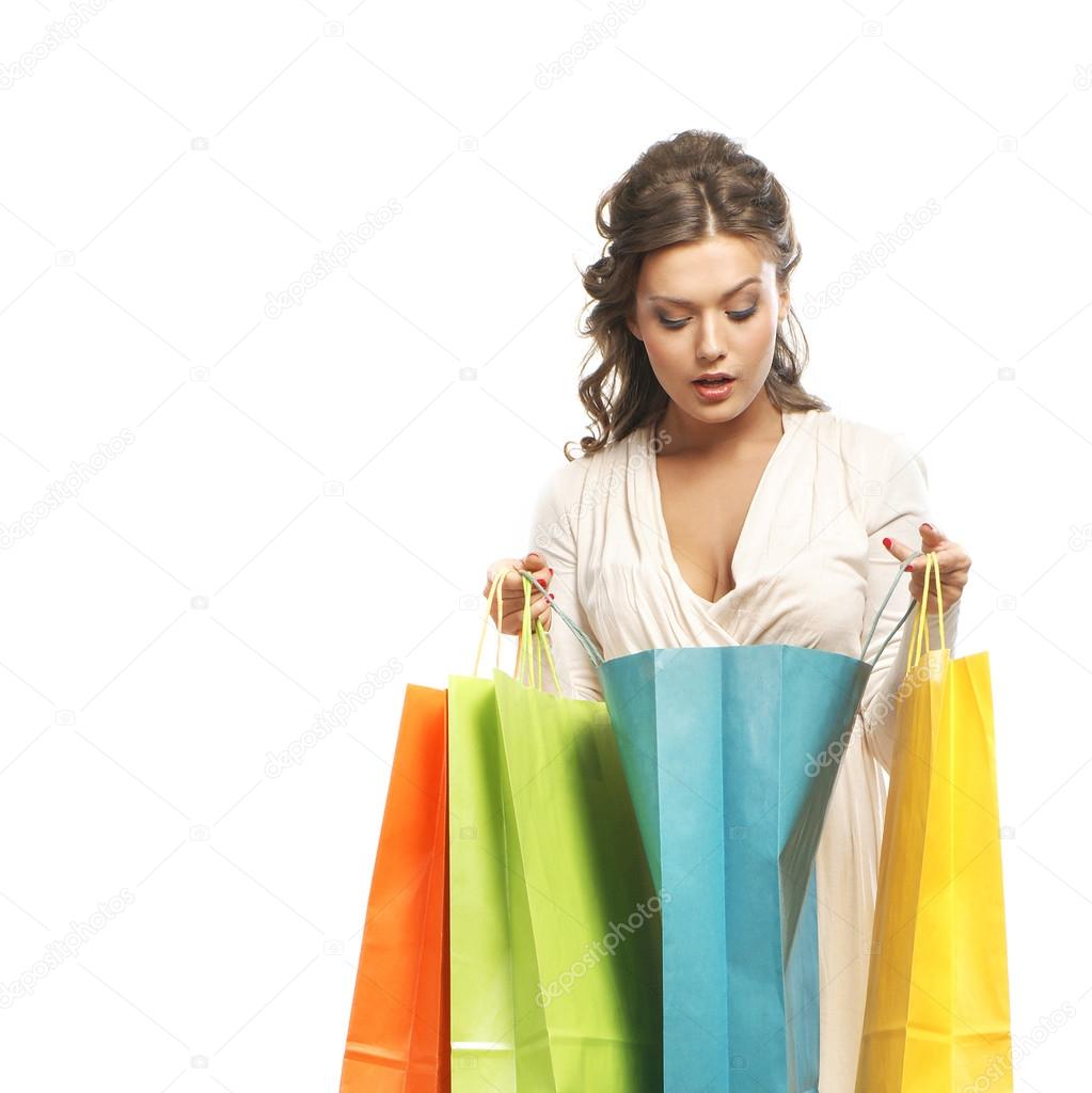 Young attractive girl with the shopping bags isolated on white