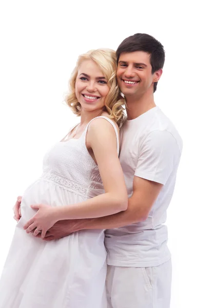 A young attractive couple: pregnant mother and happy father isolated on white — Stock Photo, Image