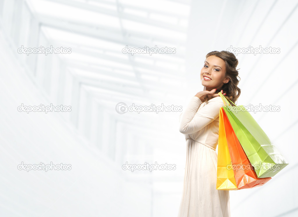 Beautiful woman with the bright shopping bags