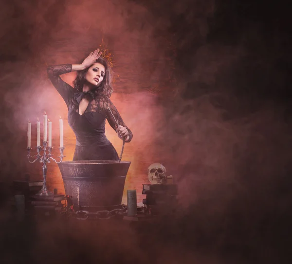 Young sexy witch making the witchcraft in the dungeon — Stock Photo, Image