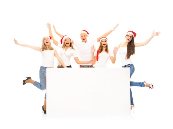 Um grupo de adolescentes felizes e emocionais em chapéus de Natal posin — Fotografia de Stock