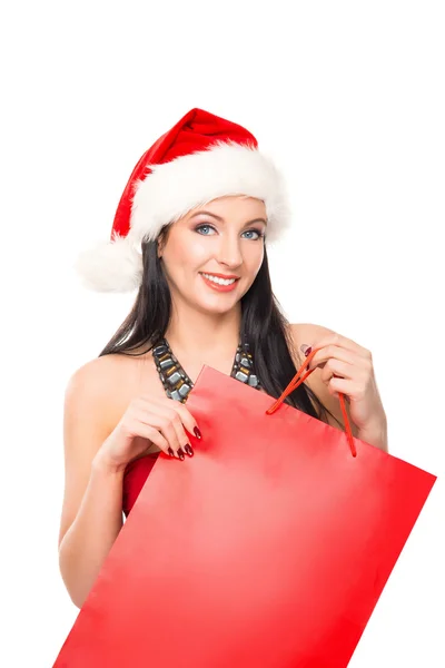 Uma mulher feliz em um chapéu de Natal segurando um saco de compras vermelho Fotografias De Stock Royalty-Free