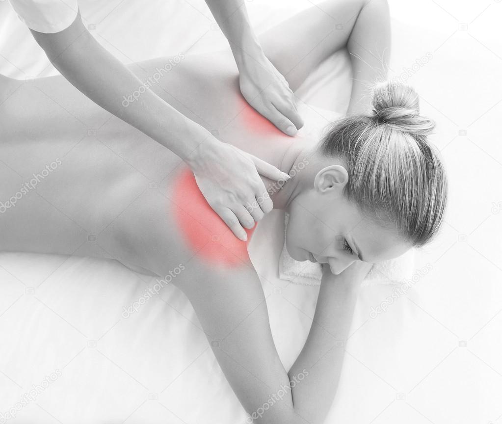 A young woman relaxing on a back massage procedure