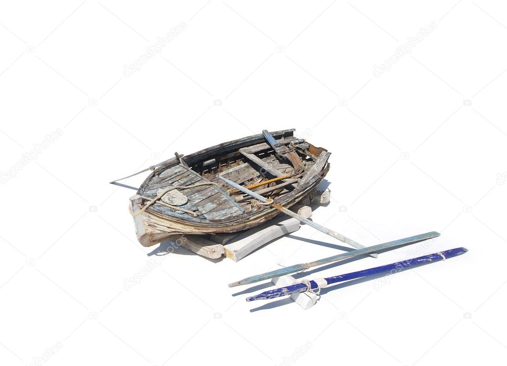Old, shabby and holey boat isolated on white