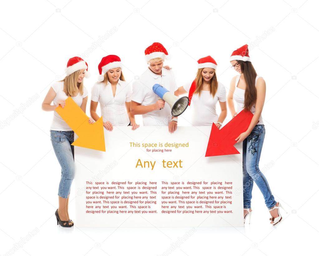 A group of teenagers in Christmas hats pointing on a blank banne