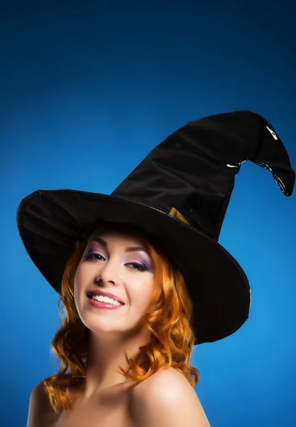 Portrait of a happy woman in a black witch hat — Stock Photo, Image