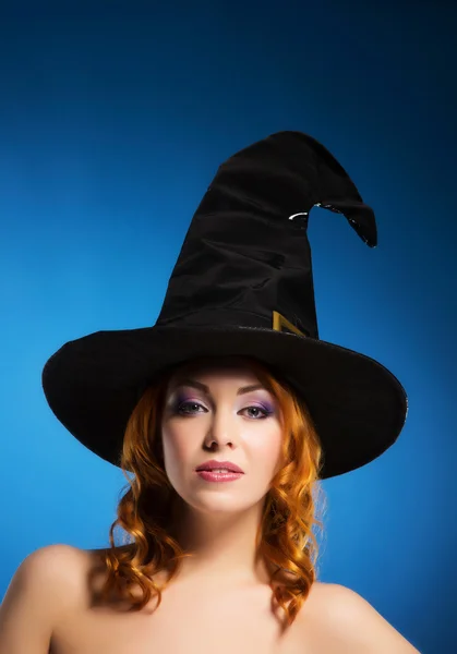 Portrait of a happy woman in a black witch hat — Stock Photo, Image