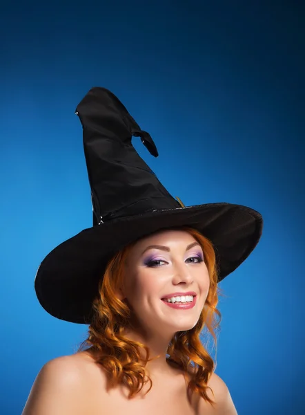 Portrait of a happy woman in a black witch hat — Stock Photo, Image