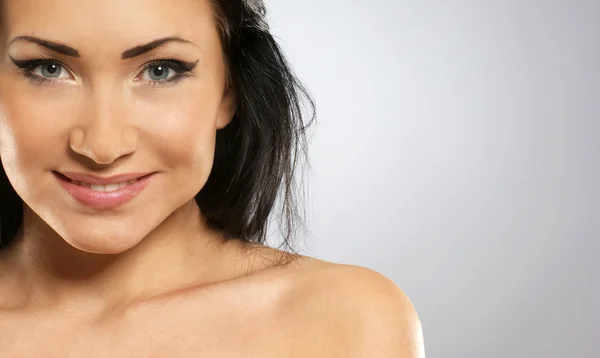 Portrait of young and fresh asian brunette over grey background — Stock Photo, Image