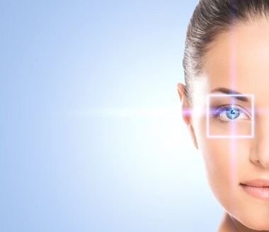 Portrait of a young woman with a laser hologram on her eye