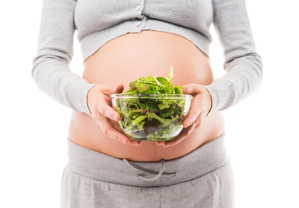 A pregnant woman holding a fresh green salad — Stock Photo, Image