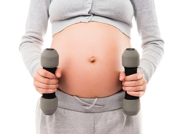 A pregnant woman working out with dumbbells — Stock Photo, Image