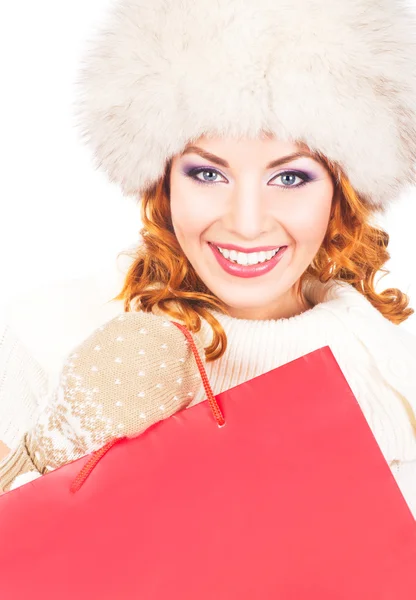 Portrait of a young woman in winter clothes holding a present — Stock Photo, Image