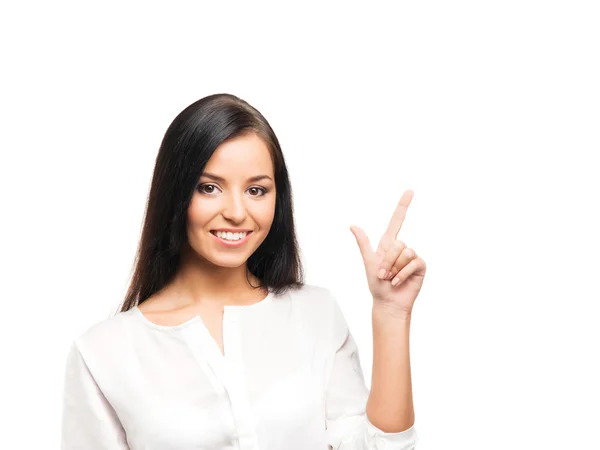 Eine junge Geschäftsfrau zeigt auf etwas auf Weiß — Stockfoto