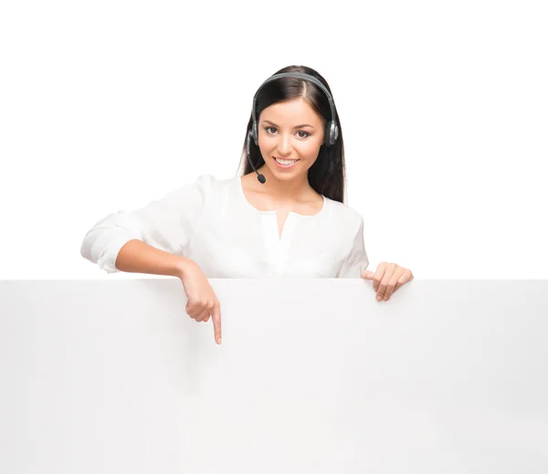 A young brunette businesswoman with a huge white blank banner — Stock Photo, Image