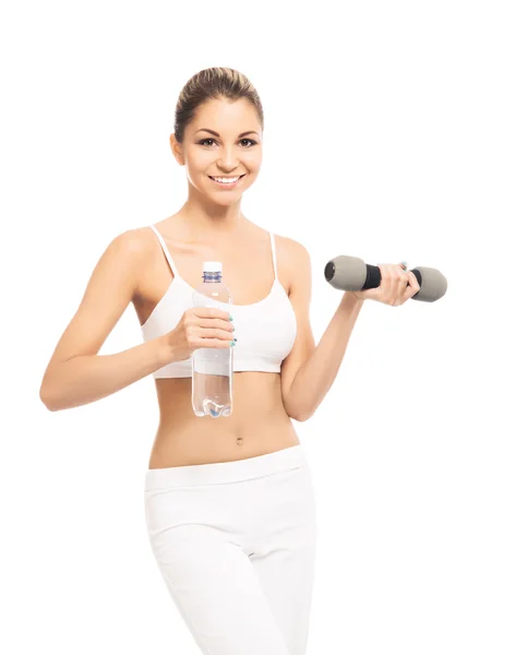 Una mujer joven y en forma haciendo ejercicio con pesas —  Fotos de Stock