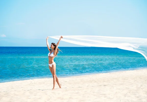 A woman in a swimsuit on a sea resort background — Stock Photo, Image