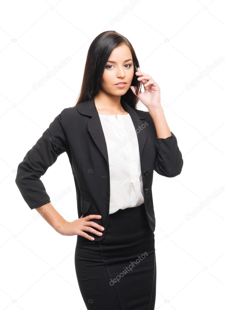 A young businesswoman with a smartphone on white
