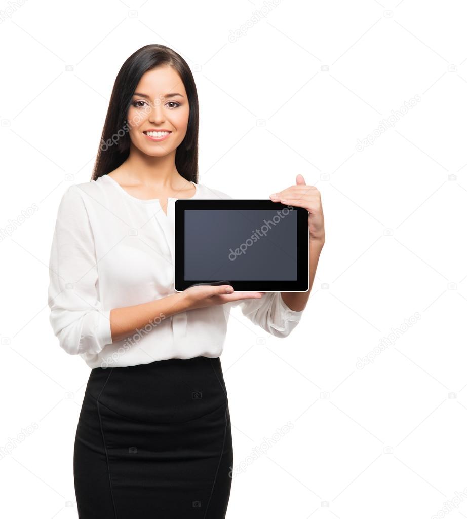 A young brunette businesswoan holding a tablet computer