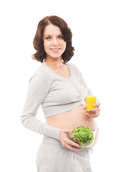 A young brunette pregnant woman isolated on a white background — Stock Photo, Image