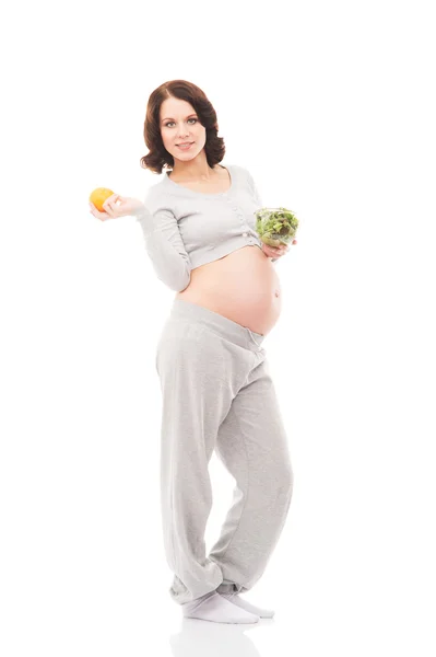Eine junge brünette schwangere Frau isoliert auf weißem Hintergrund — Stockfoto