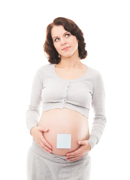 Een jonge brunette zwangere vrouw geïsoleerd op een witte achtergrond — Stockfoto