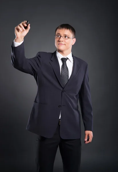 A smart businessman writing with a marker on the screen — Stock Photo, Image