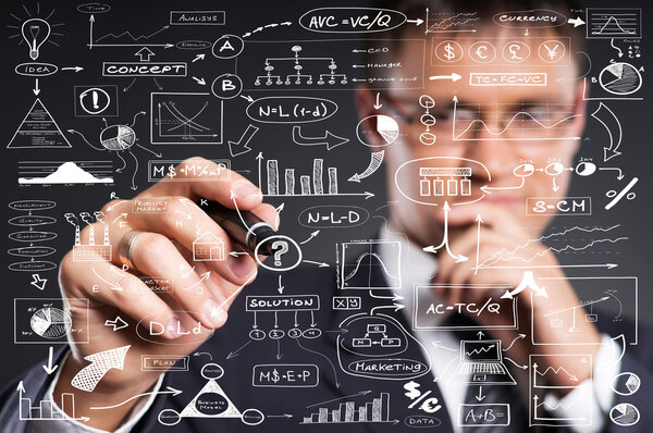 A smart businessman writing with a marker on the screen