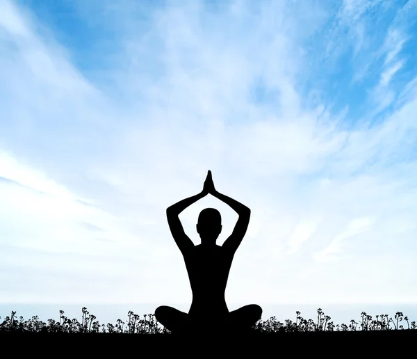 Silhouette of a woman doing yoga exercise — Stock Photo, Image