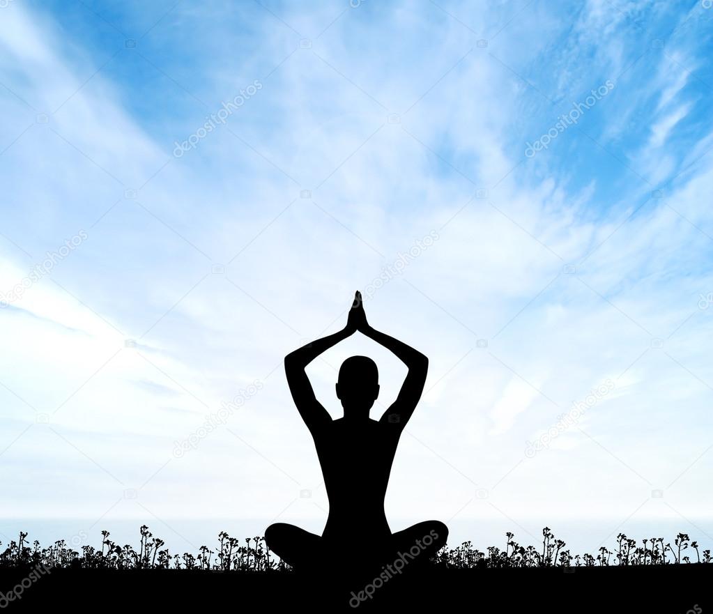 Silhouette of a woman doing yoga exercise