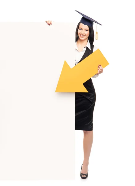 Graduate girl pointing on a blank banner — Stock Photo, Image