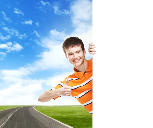 Teenage boy with a blank banner — Stock Photo, Image