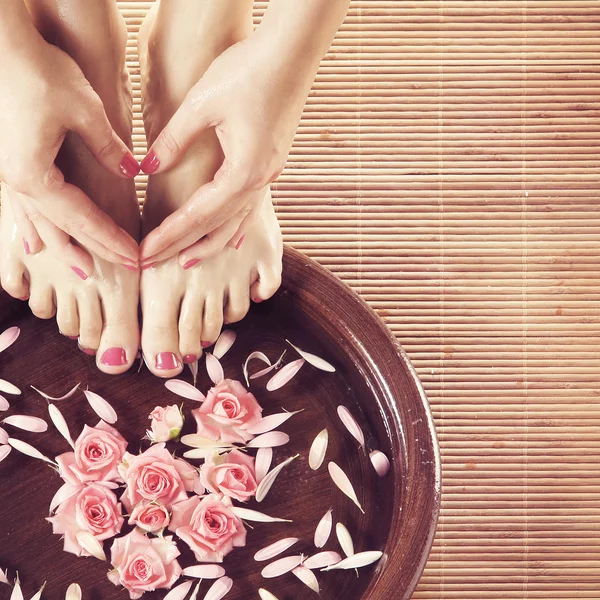 Beautiful female legs in spa composition — Stock Photo, Image