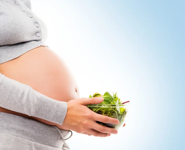 Pregnant woman with fresh green salad — Stock Photo, Image